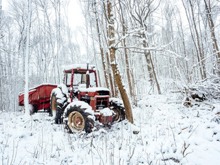 Abandoned tractor in the snow, pollution