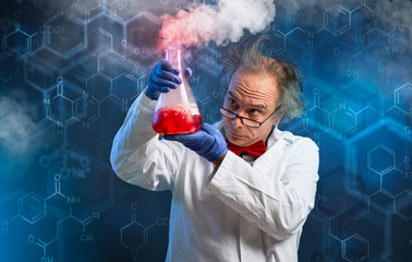 chemist carefully oversees his experiment - obrazy, fototapety, plakaty