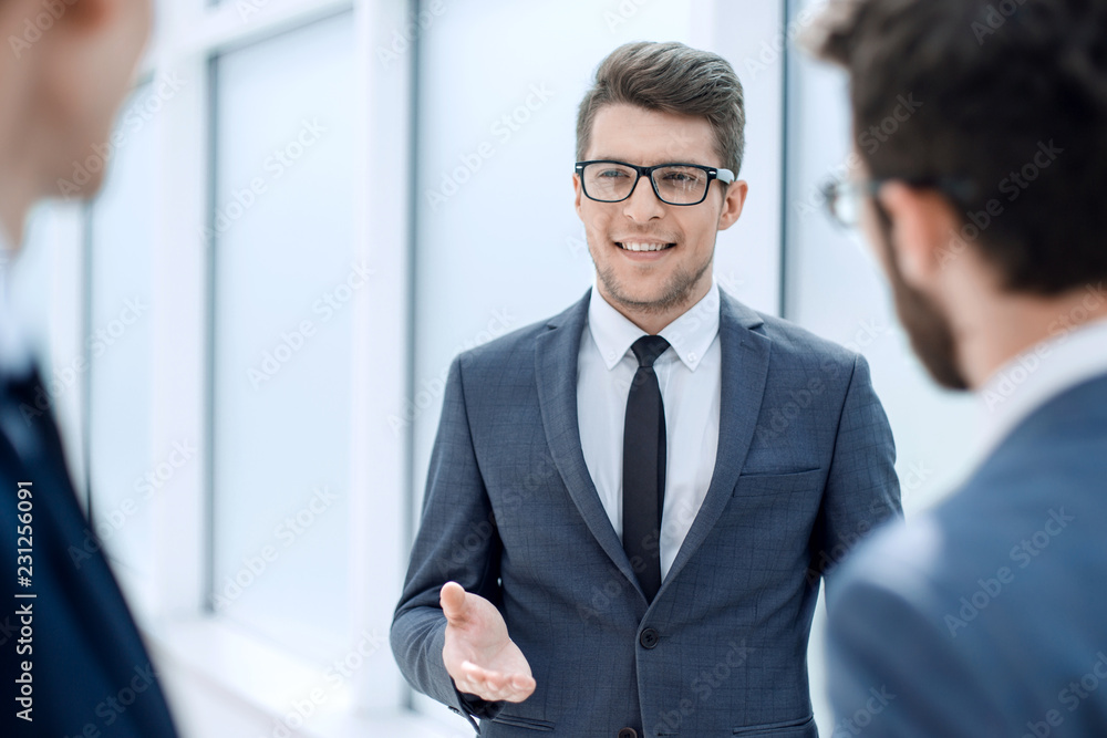 Wall mural boss talking to employees standing in the office