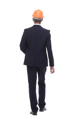 businessman in a protective helmet confidently stepping forward