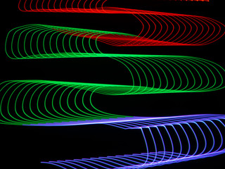 Light painting with red, gree, and blue to create a ribbon effect that is abstract.