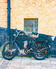 Fototapeta na wymiar Black bike against a black wall