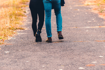 Boots and jeans,couple walking in the park.