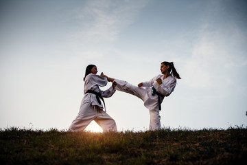 Martial training, two girls karate fight.