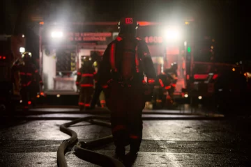 Room darkening curtains United States Firefighter walking on a building fire emergency