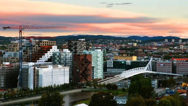 Oslo, Norway. A sunrise view of Sentrum area of Oslo, Norway, with Barcode buildings and the river Akerselva. Construction site with morning colorful sky. Zoom in