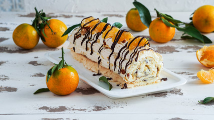 meringue roulade with cream and tangerines