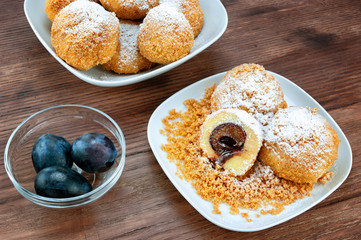 Plum dumplings on wooden table