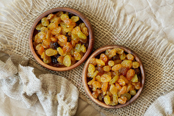 Golden raisins surrounded by decorative burlap fabric.