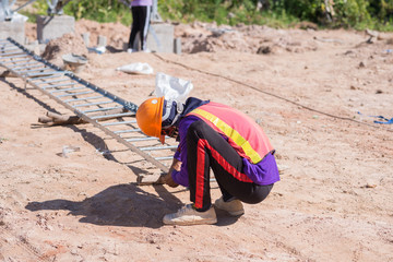 Construction worker connects steel