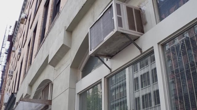 Building with air conditioner unit on exterior of window.
