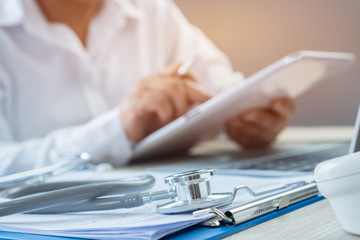 Healthcare medical concept, Hands Doctor's writing and working by stylus for order medication on...