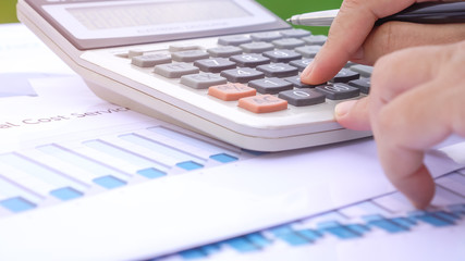 Paperwork Accounting planning budget concept : Accountant hands calculate financial report graph chart, counting on calculator for checking financials data analyzing documents report in busy office
