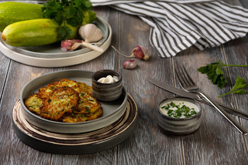 zucchini fritters on wooden table