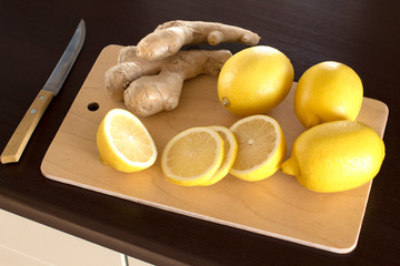 lemons and ginger root on a cutting board