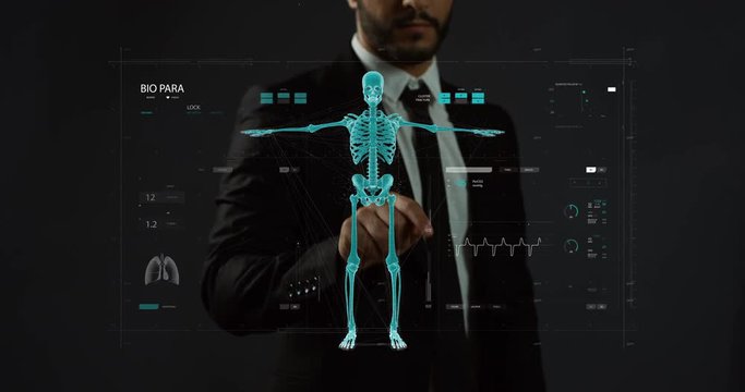 Caucasian man in the suit and tie controlling the processing of the futuristic 3D hologram of man robot modelling. Close up.