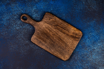 Cutting board on a blue background, top view