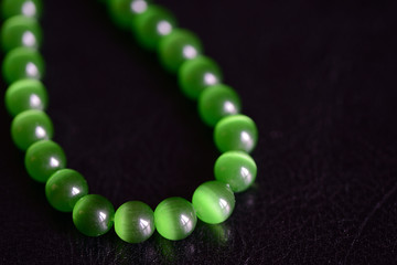 Green stone necklace on a dark background close up