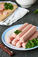 Raw sausages with parsley on a plate