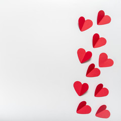 red paper hearts on white background