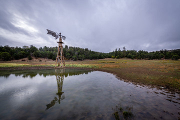Obraz premium Reflections of a Dilapidated Windmill