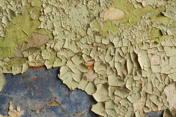 Old cracked and peeling paint on the old wall.