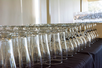 Glasses along a bar ready for event