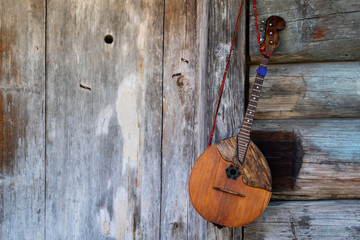 Old russian balalaika on the background of wooden boards.
