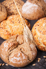 Wholegrain rolls or bread with seeds and ears of rye grain