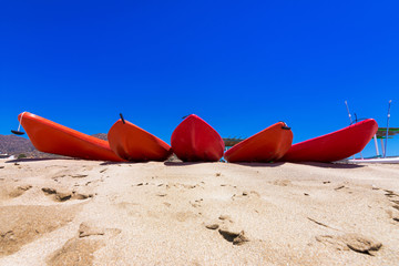 Fototapeta na wymiar Kayak boards in Maganari beach, Ios island, Cyclades, Greece