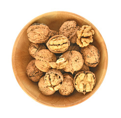 Top view of Walnuts kernels in wooden bowl on white background