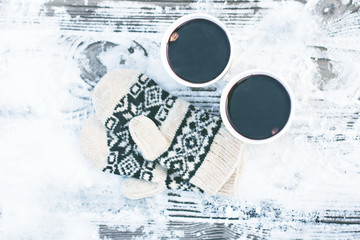 paper craft glass,  cup  with a hot drink, coffee, cocoa, mulled wine and white and black mittens