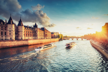 Dramatic sunset over Cite in Paris, France, with Conciergerie, Pont Neuf and river Seine. Colourful travel background. Romantic cityscape. - obrazy, fototapety, plakaty