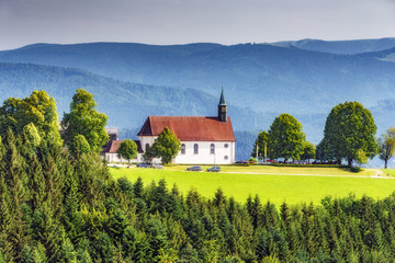 Scenic mountain landscape with an old church in the Black Forest, Germany. Colorful travel background.