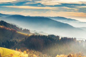 Scenic mountain landscape. View on the Black Forest, Germany, covered in fog. Colorful travel background. - obrazy, fototapety, plakaty