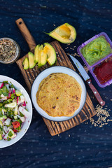 Chapati whole wheat grain flat bread. Indian traditional food. Served with avocado sauce, tomato sauce, fresh vegetables salad. Vegan vegetarian healthy paleo diet