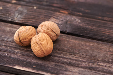 Walnuts on dark vintage table, Walnuts kernels in wooden bowl. Walnut healthy food