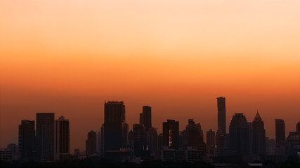 Sunset with orange sky cityscape view.