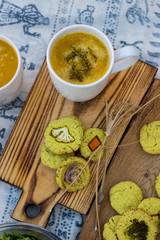 Hot broth vegetable soup in white cup with herbs, spices and greens. Fresh spinach avocado salad and corn turmeric bread with vegetables. Autumn seasonal pumpkin cauliflower puree. Paleo vegan diet