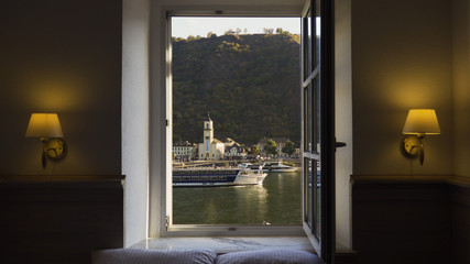 View from hotel window on the Rhine as a cruise boat travels past.