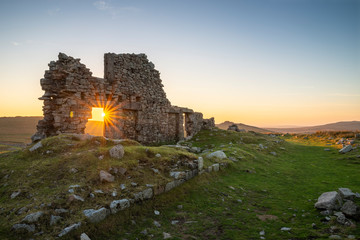 Stunning landscape sunset image over abandoned Foggintor Quarry in Dartmoor with raking soft...