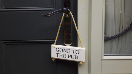  "Gone to Pub" sign hanging on door.