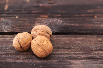 Walnuts on dark vintage table, Walnuts kernels in wooden bowl. Walnut healthy food
