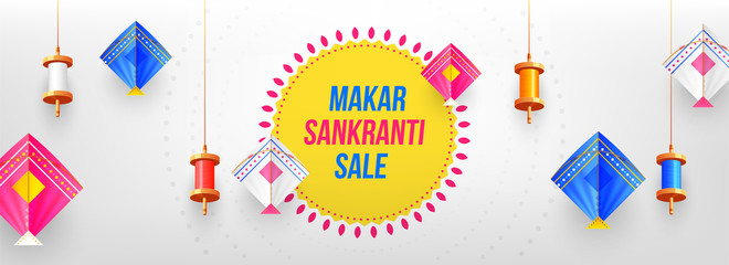 Decorative colorful spools and kites on glossy gray background for celebration of Makar Sankranti festival. Website header or banner design.