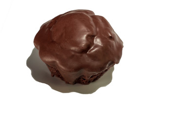 Single chocolate black cupcake coated in chocolate isolated on white background from above