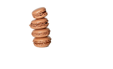 Stack of four freshly baked brown macaron cookies isolated on white background