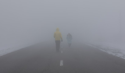 man and little girl in the fog