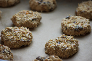 Oat cookies with raisins before bakery. Homemade food. Grey background. Cooking process.