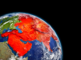 Asia from space. Planet Earth with extremely high detail of planet surface and clouds. Continent highlighted in red.