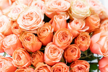 Roses peach and orange pastel colors. Bright bouquet in metal bucket. concept of flower shop.